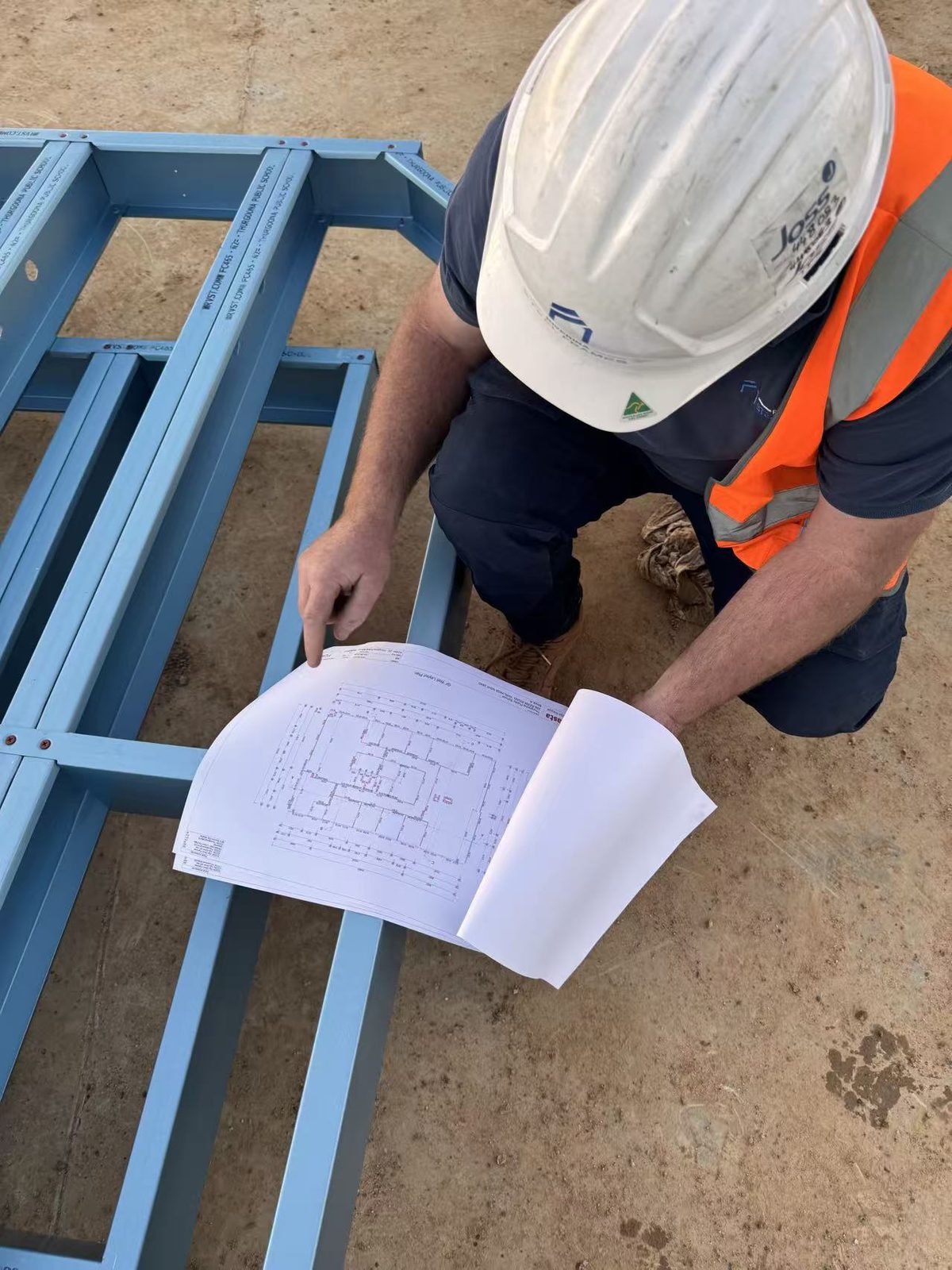 Installer checking a prefabricated wall panel against the engineering plan